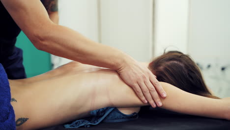 woman enjoying massage in spa salon. female enjoying relaxing back massage in cosmetology spa centre