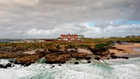 aerial drone shot over the rocky coastline in newquay, cornwall, united kingdom