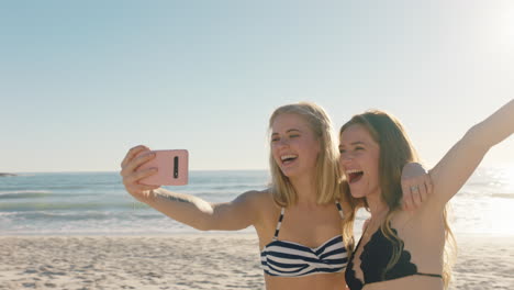 best friends taking selfie photo on beach using smartphone teenage girls sharing summer vacation enjoying summertime by the sea