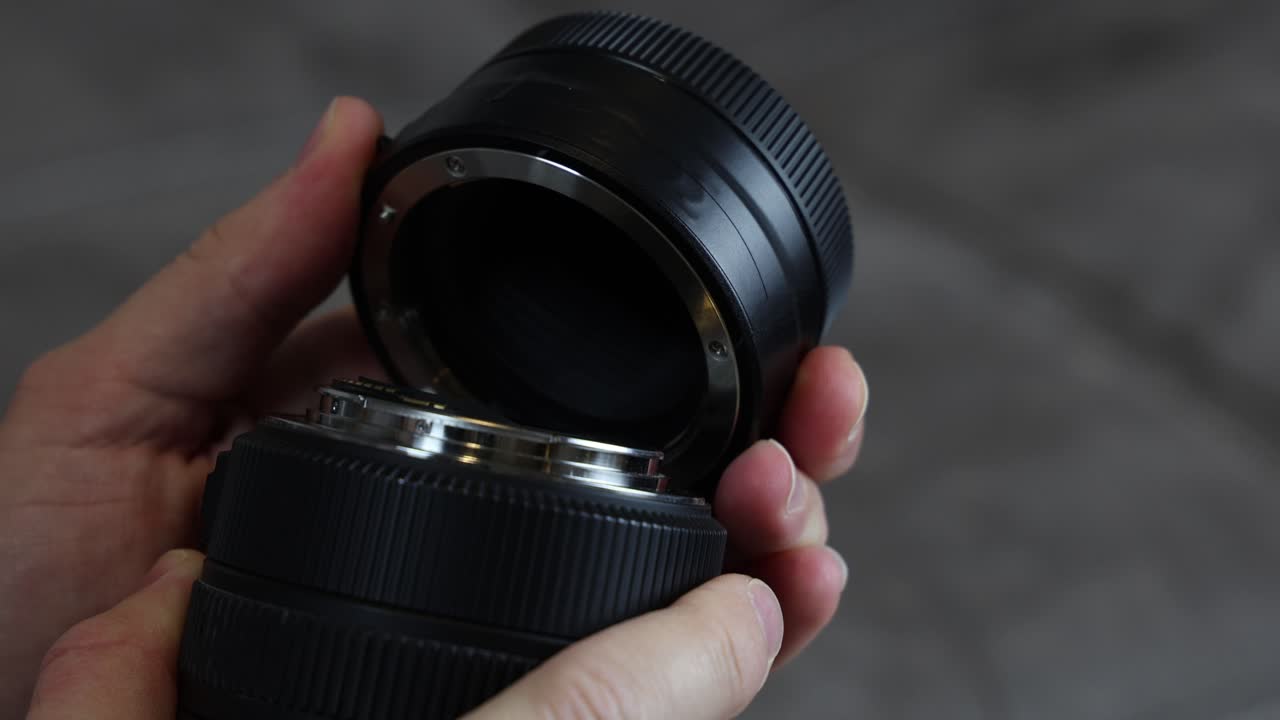 Camera lens adapter on a professional lens, isolated close up