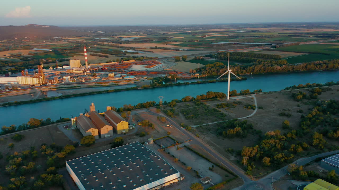 Aerial shot from above of five Wind Turbines near a river in Southern France at sunset
