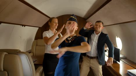 businesspeople dancing inside of aircraft first class