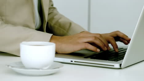 Businesswoman-typing-on-her-laptop