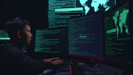 asian boy hacker using multiple computer hacking and success downloading data