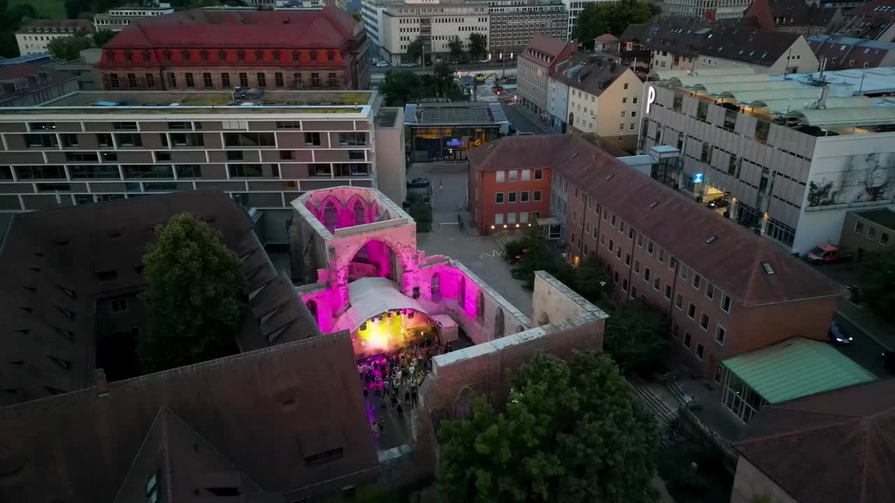 4K Aerial Drone Video of Fans Watching a Band Perform in the Ruins of a Medieval Church in Nurnberg, Germany
