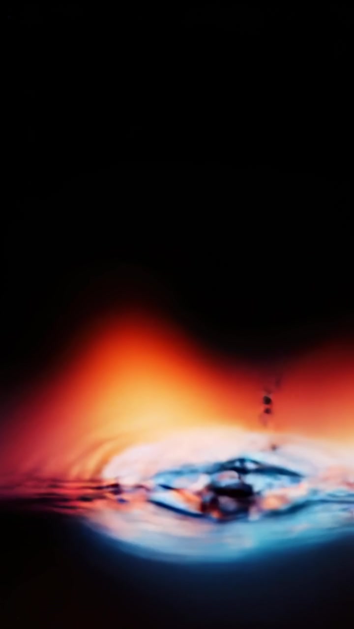 Single Water Drop Creating Ripples in Vibrant Gradient Light