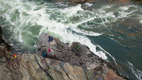 fishing for a salmon using traditional native american net on a river in the interior of bc