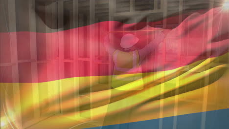 animation of flag of germany waving over caucasian male engineer wearing helmet taking measurements