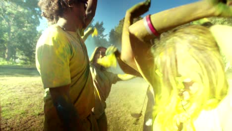 multi-ethnic group celebrating holi festival in park
