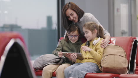 woman with children in departure lounge