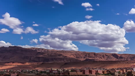 cinematic timelapse of moving clouds and shadows falling on the high atlas mountain of tinghir town, the moroccan crown jewel