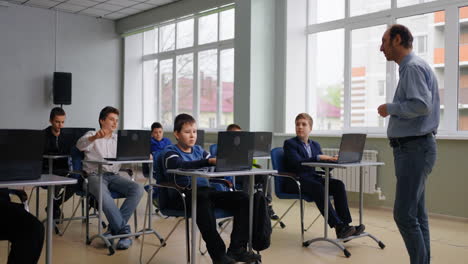 students in a computer class with a teacher