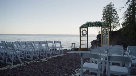 panning shot of a wedding ceremony location with many white chairs