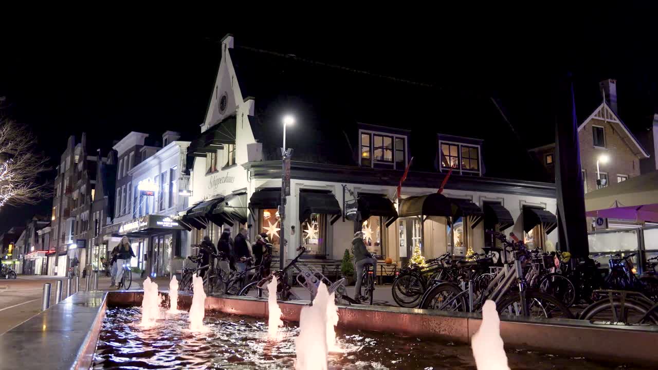 City at Night with Fountain and People