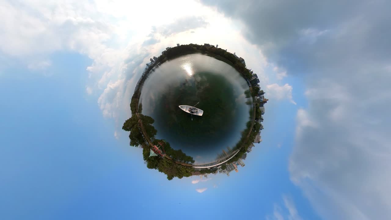 Time-lapse of couple rowing the boat on the lake. 360-degree, little planet, planet earth.