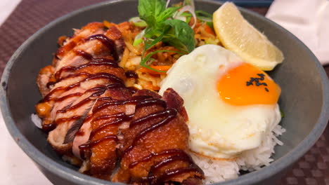 tasty thai crispy fried duck with fried egg, vegetables and white rice, spicy asian food, 4k shot