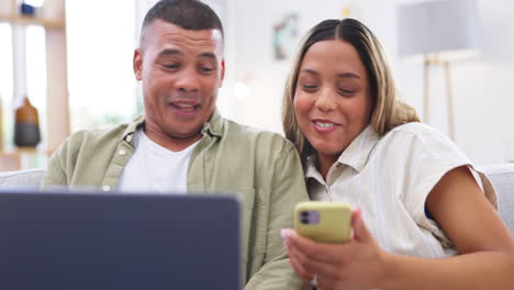 teléfono, portátil y pareja divertida en el sofá en casa