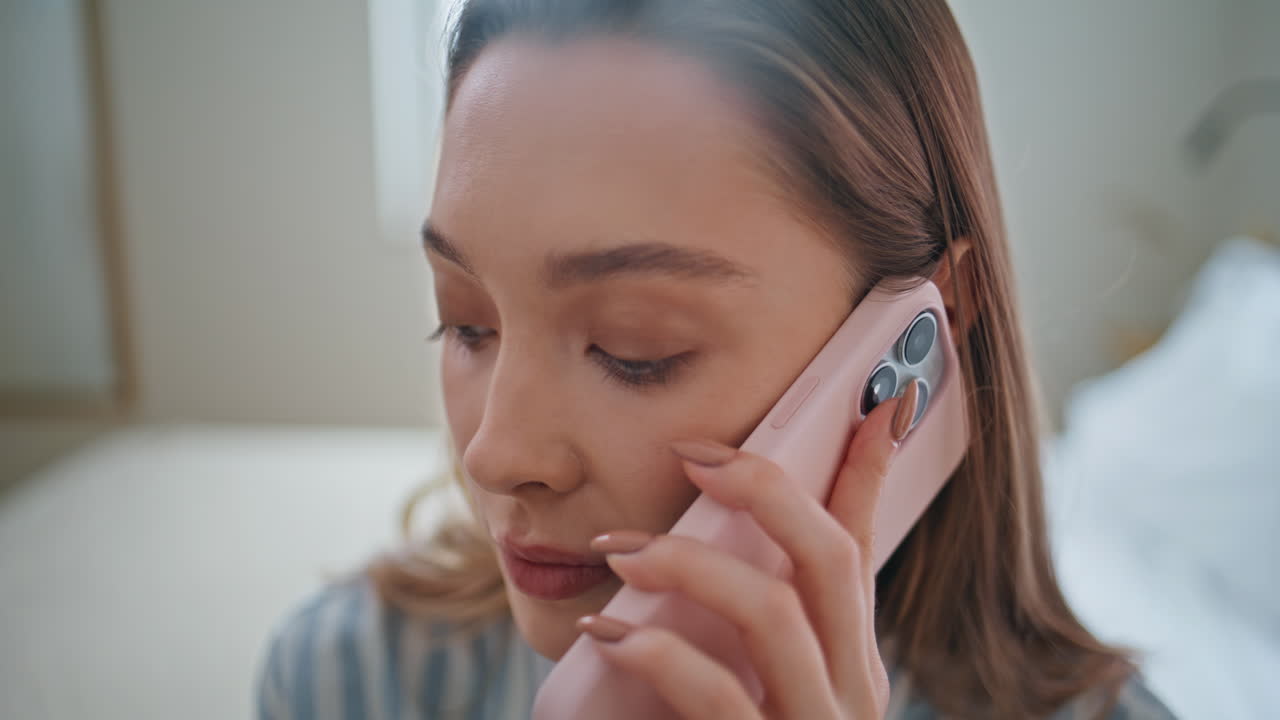 Woman chatting mobile phone in apartment closeup. Portrait serious girl talking