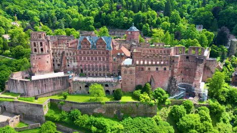 4k aerial drone video of ruins of historic castle on königstuhl hill overlooking heidelberg, germany