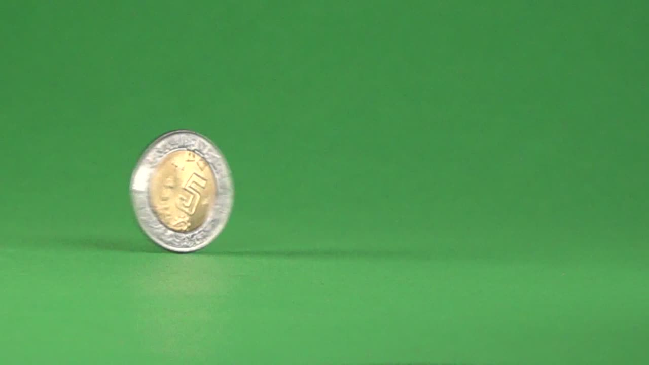5 Mexican pesos spinning, on a chroma background