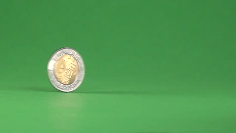 5 mexican pesos spinning, on a chroma background