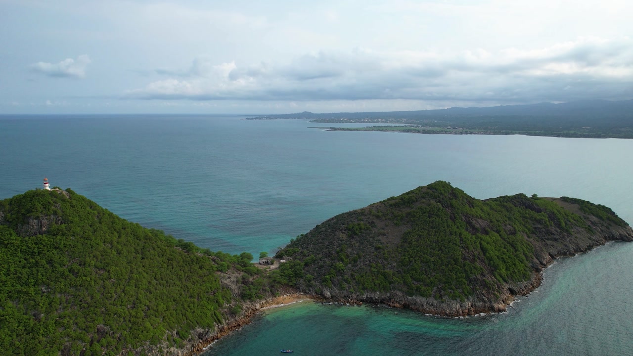 Aerial tracking shot in front of a Lighthouse and Ilhéu das Cabras, Sao Tome