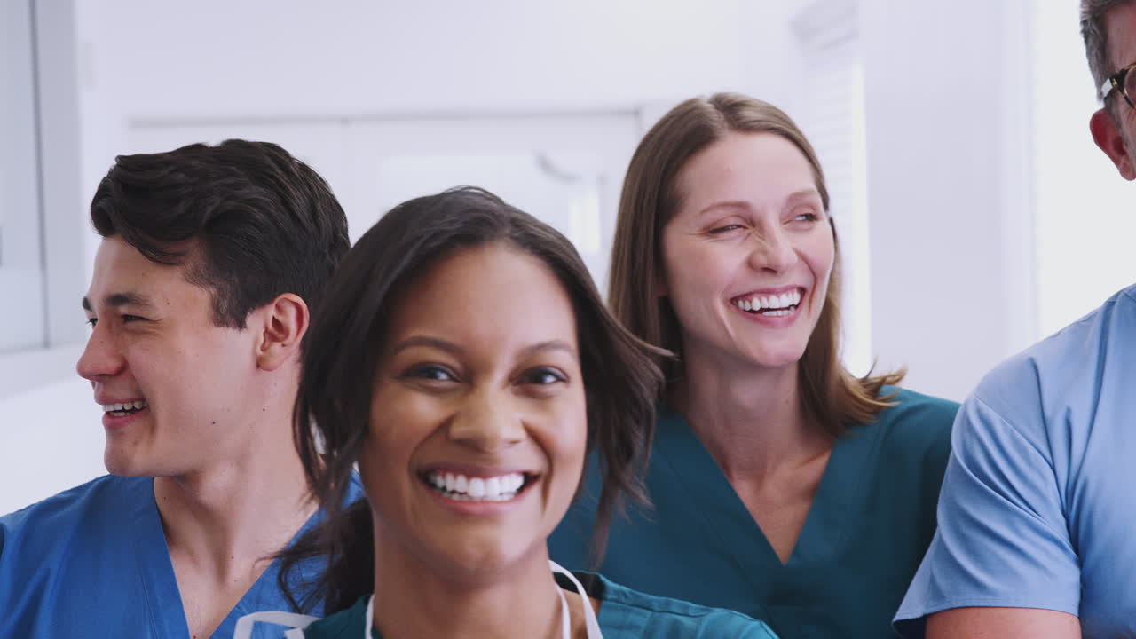 Portrait Of Smiling Multi-Cultural Medical Team Standing In Hospital Corridor