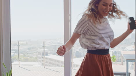 beautiful woman dancing at home having fun celebrating lifestyle achievement enjoying happy dance in penthouse apartment