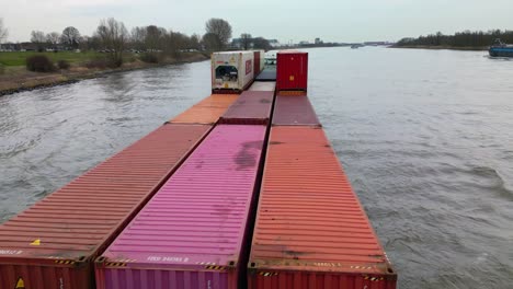 Close-up-shot-of-large-container-ship-loaded-with-containers-sailing-in-river,-Zwijndrecht,-The-Netherlands