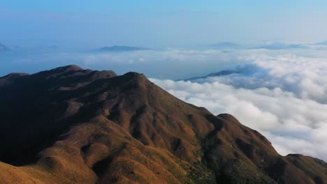 scenic aerial shot of clouds around sunset peak, hong kong, illuminated by sunlight