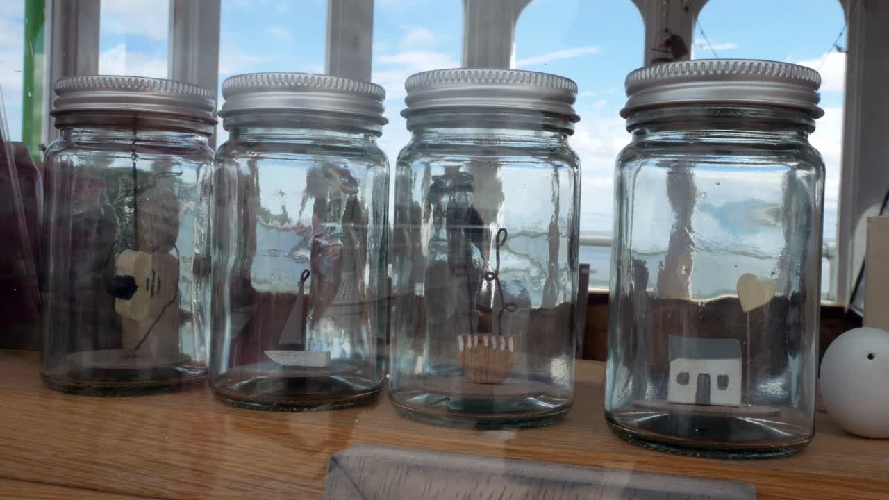 Glass jars filled with important life choices wooden models dolly left