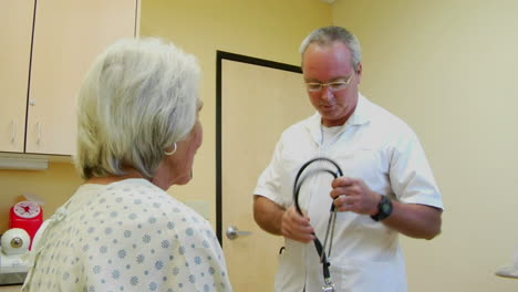 a doctor uses a stethoscope to listen to a patient's heart and lungs