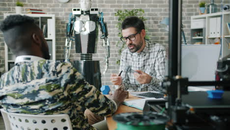 two men collaborating on a 3d printing project in a modern office