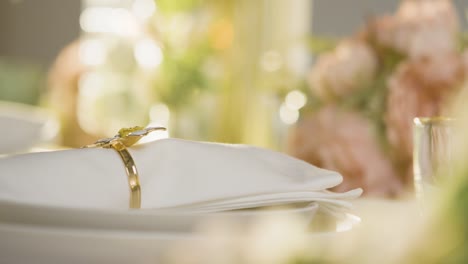 close up of napkin in ring on table set for meal at wedding reception in restaurant 1