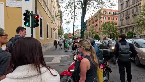 pedestrians crossing street at traffic light