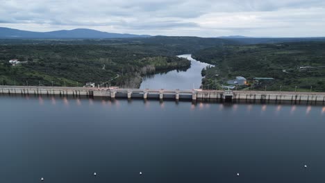 drone footage of a reservoir surrounded by nature in cáceres, extremadura — peaceful landscape and calm water in rural spain