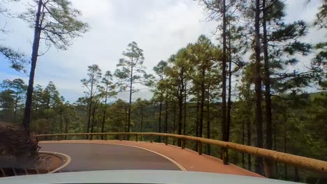 A-Timelapse-Journey-on-a-Winding-Mountain-Road,-Through-Lush-Greenery-and-Clear-Skies,-with-Views-of-the-Atlantic-Ocean,-in-La-Gomera,-Canary-Islands,-Spain