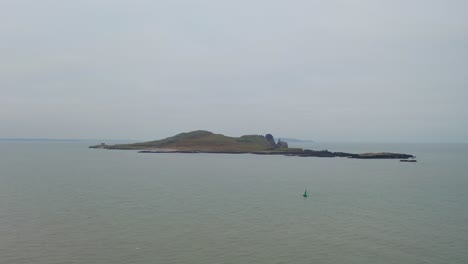 Aerial-tracking-shot-takes-altitude-revealing-the-whole-Ireland's-eye-island