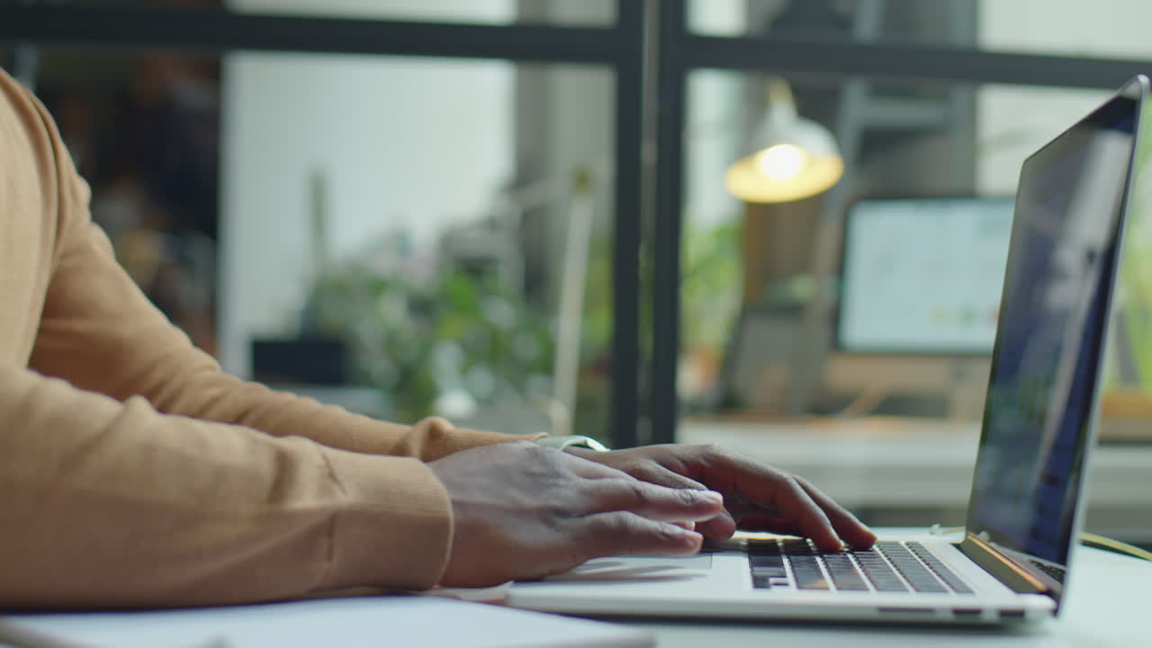 Businessman Typing Financial Report on Laptop