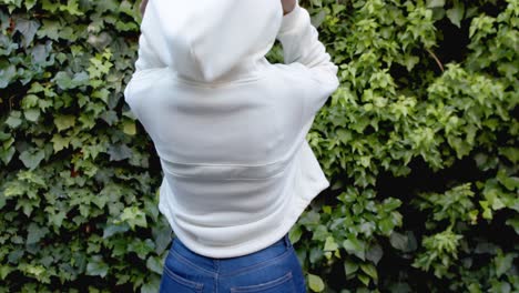 rear view of african american woman in white hooded sweatshirt, slow motion, copy space