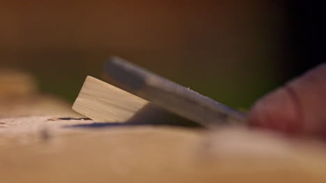 The-calloused-hands-of-a-craftsman-using-a-file-to-shape-wood---close-up-isolated-in-slow-motion