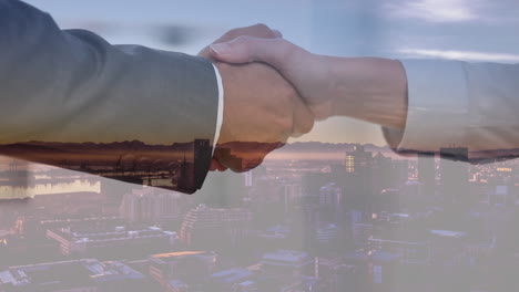 handshake with city in background