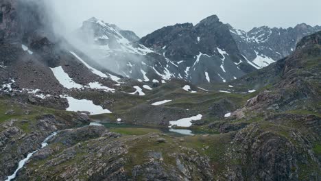 Misty-mountain-landscape-with-Cascata-di-Stroppia-and-Lago-Niera,-serene-natural-scenery