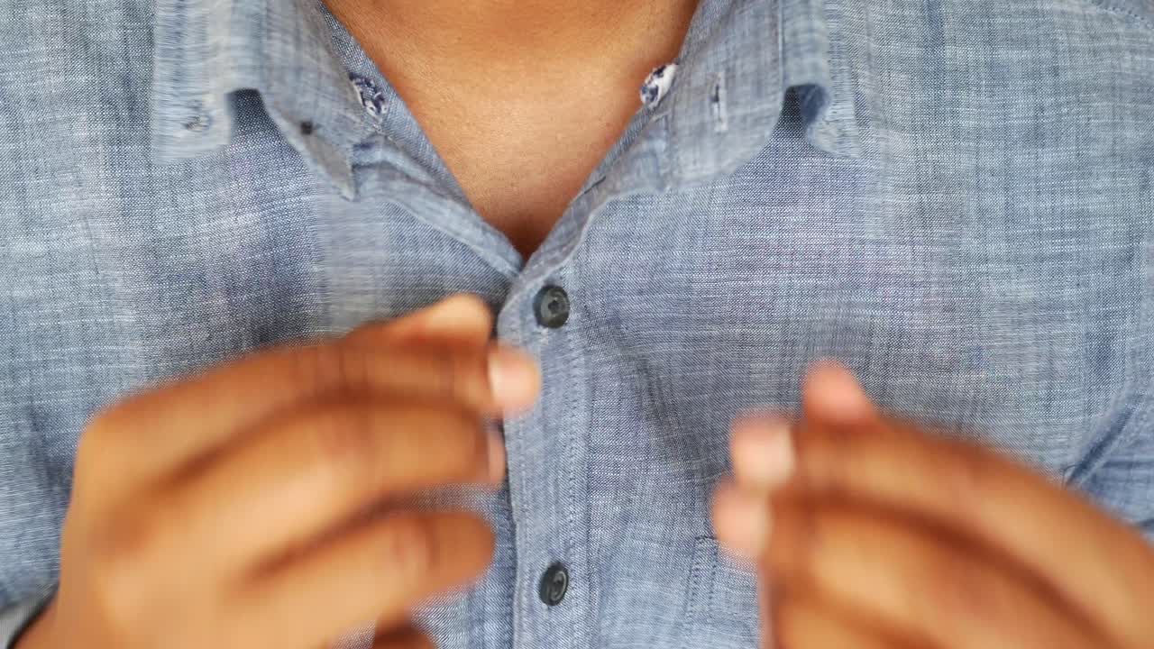 Man Buttoning His Shirt