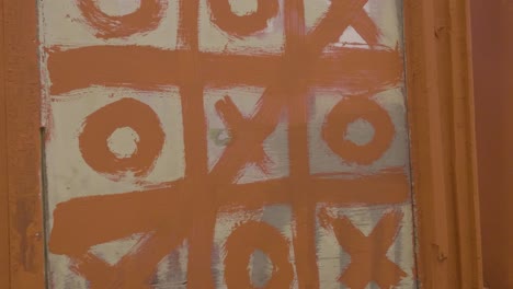 painted tic-tac-toe on a door