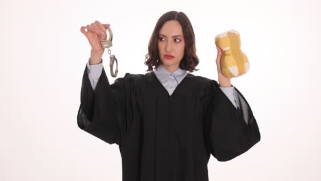 female judge holding handcuffs and a symbolic object representing justice