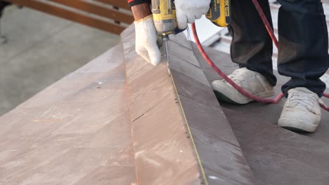 asian worker doing roof installation on site, close up