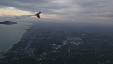 aerial view of chicago illinois over downtown and lake michigan out of plane window 4k