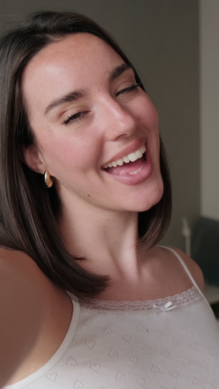 Happy Woman Taking a Selfie Video in Bedroom