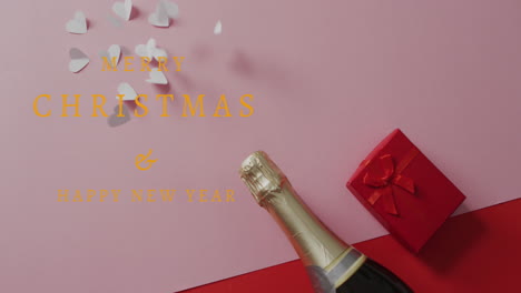 animation of happy new year text over champagne, hearts and red present